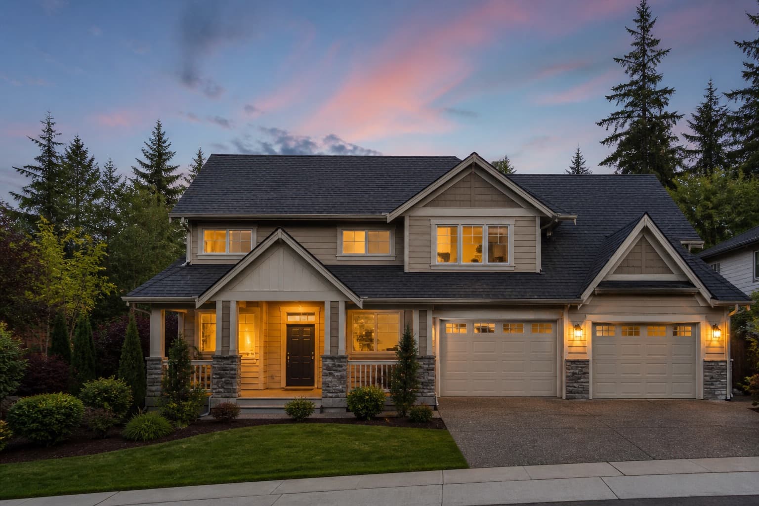 Residential home with a newly installed asphalt shingle roof at dusk